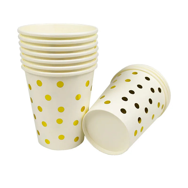 A set of white disposable cups and a lid with a gold dot pattern.