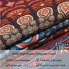 Close-up of a dark fabric tapestry featuring celestial stars, moons, and floral patterns in orange, red, and gold tones.