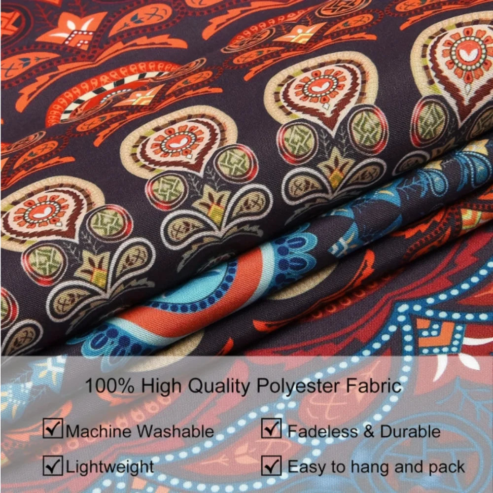 Close-up of a dark fabric tapestry featuring celestial stars, moons, and floral patterns in orange, red, and gold tones.