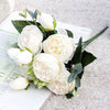 A bouquet of white silk roses and peonies with green leaves displayed on a white background.