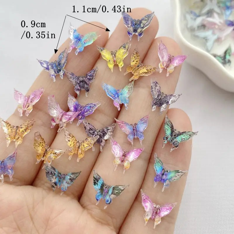 A hand holds a collection of 30 colorful resin butterfly embellishments in various shades of purple, blue, and yellow.