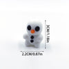 A small white 3D printed cartoon animal figurine with black eyes and an orange nose.