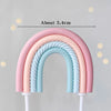 A rainbow-shaped cake topper set featuring pink and blue colors, measuring about 5.4cm.