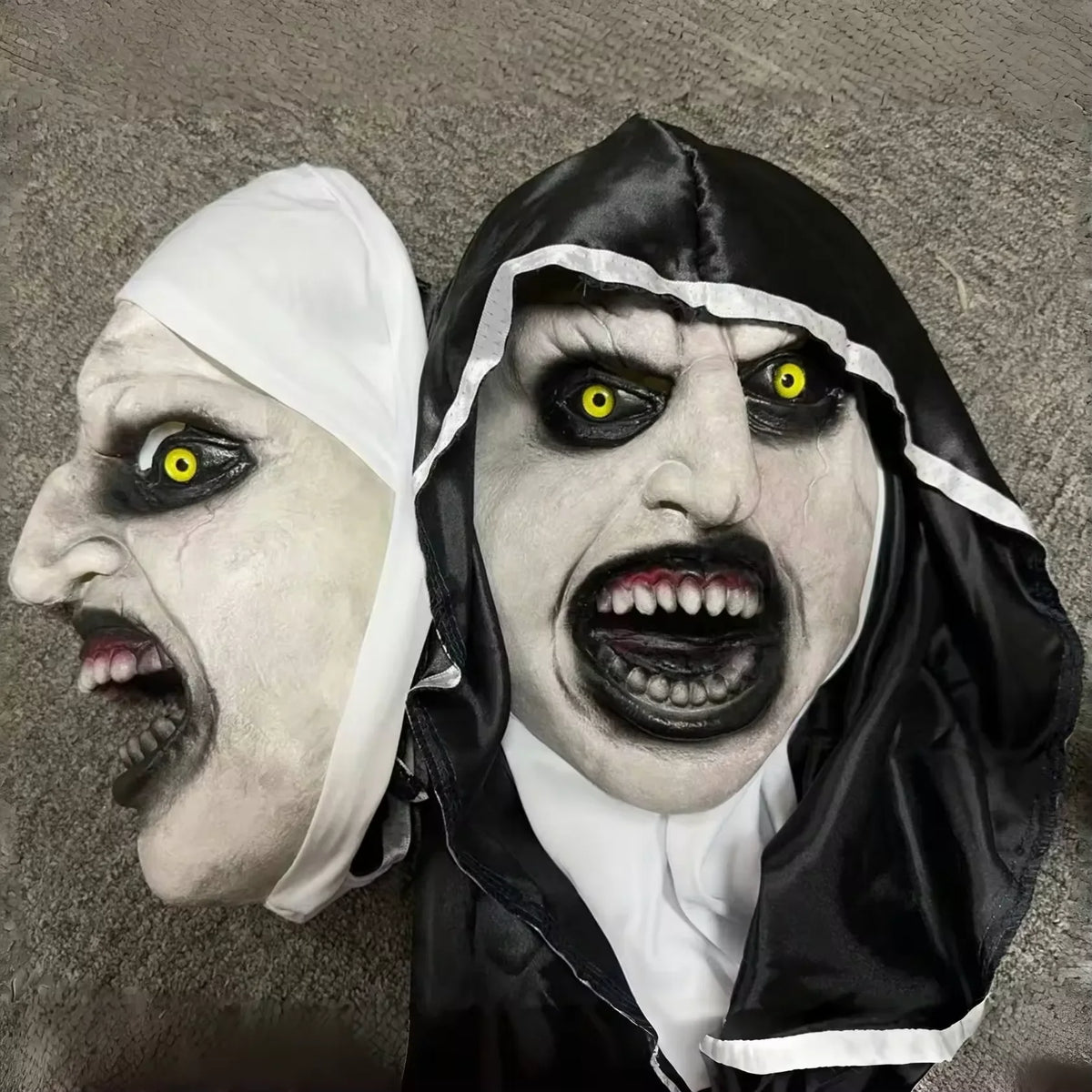 A realistic horror mask featuring pale skin, intense yellow eyes, and a black hood with white trim.