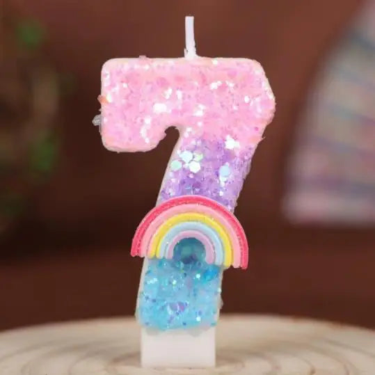 A sparkly pink and purple rainbow sequined number seven candle for a birthday cake.
