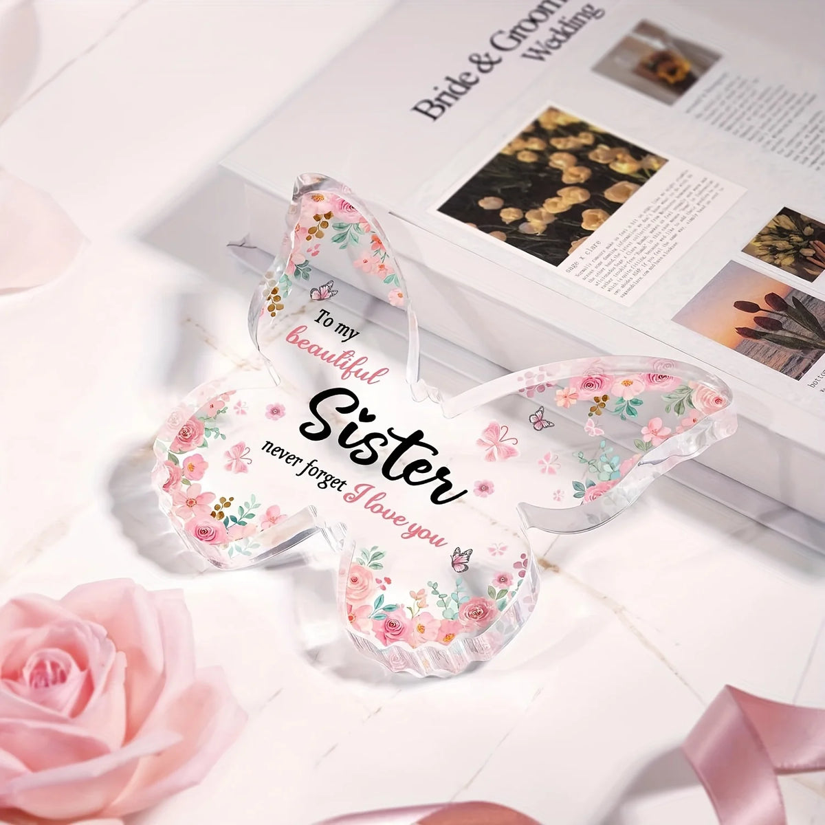 Pink butterfly acrylic keepsake gift for sister or best friend resting on a white surface.
