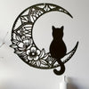 Black metal silhouette of a cat inside a crescent moon design wall decor