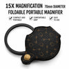 A black foldable portable magnifier with a leather case and keychain attached.