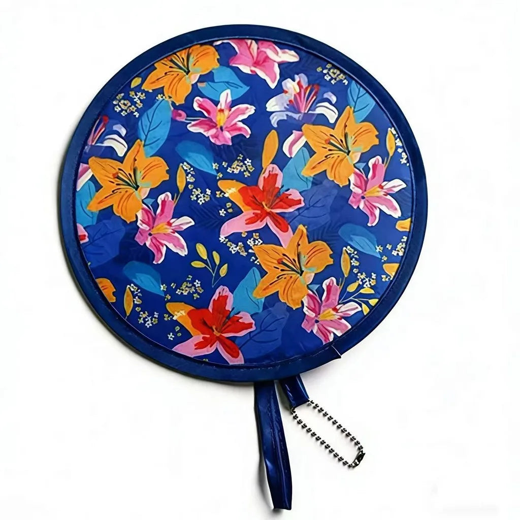 A round fabric fan with a blue background featuring colorful floral patterns in orange, pink, and yellow.