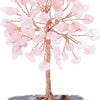 A crystal money tree decor featuring pink quartz crystals on a wooden branch set in a stone base.
