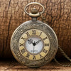 Vintage bronze quartz pocket watch with a chain and ornate engraving on the face.