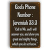 A dark brown metal sign with white text displaying the Bible verse Jeremiah 33:3