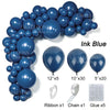 A collection of blue latex balloons, ribbon, chain, and glue for party decor.