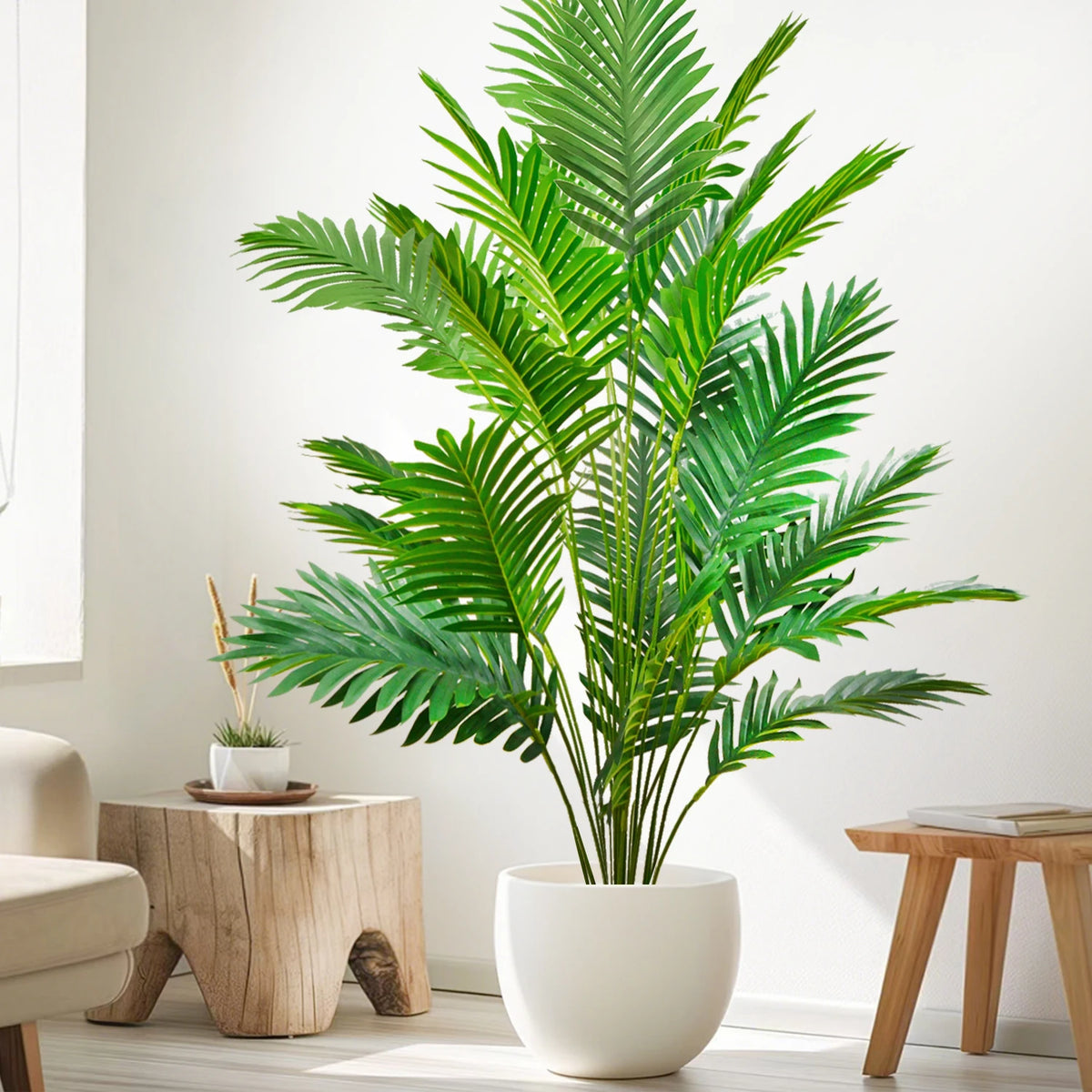 A tall artificial palm tree with vibrant green silk leaves in a white pot on a modern interior.