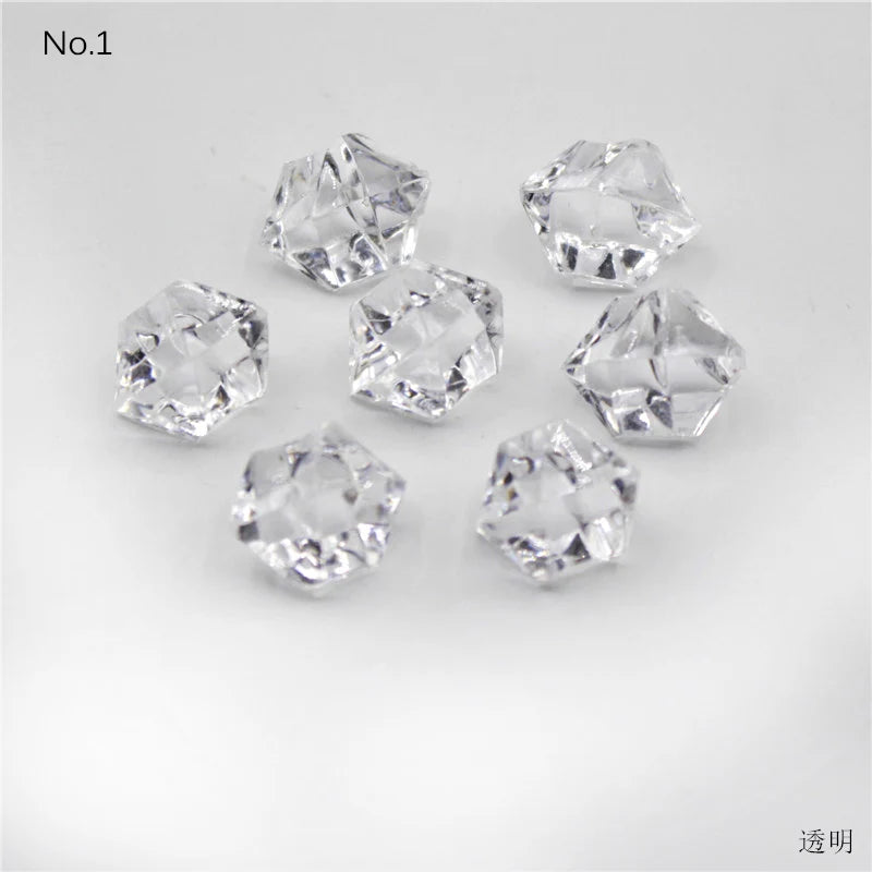 A collection of clear, faceted crystal ice cube acrylic stones for decorative use.