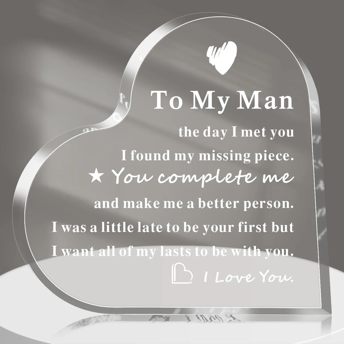 A clear acrylic heart keepsake plaque engraved with a message to her man