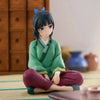 A collectible PVC figure of Maomao from The Apothecary Diaries with dark hair and purple eyes sitting on a light mat.