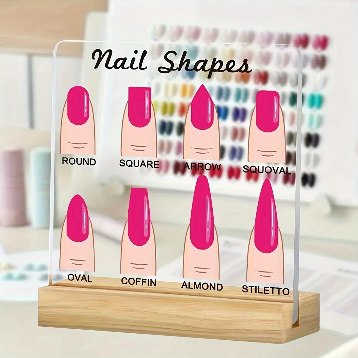 A transparent acrylic display board showing various nail shapes like round, square, arrow, and stiletto on a wooden base.