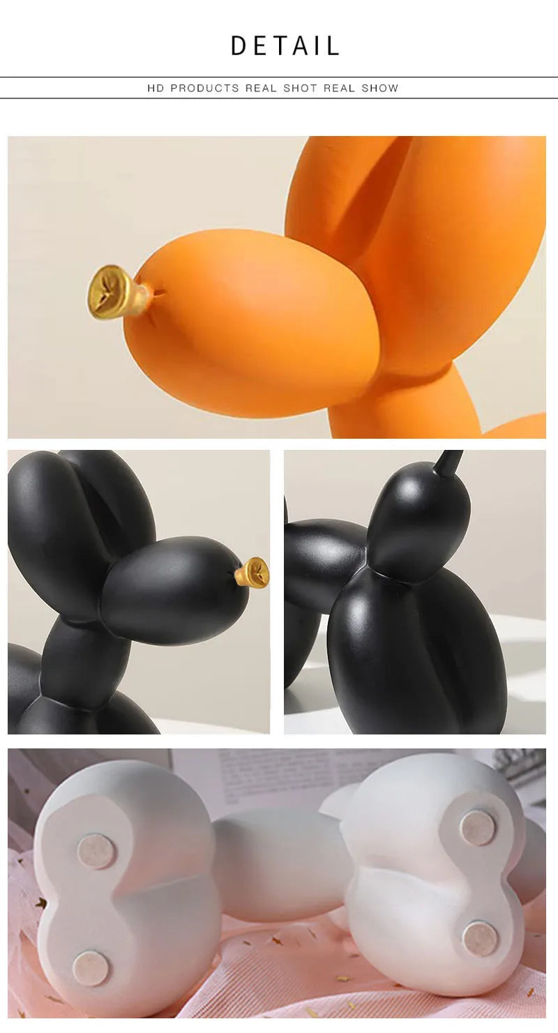 A set of modern resin sculptures shaped like balloons in orange, black, and white.