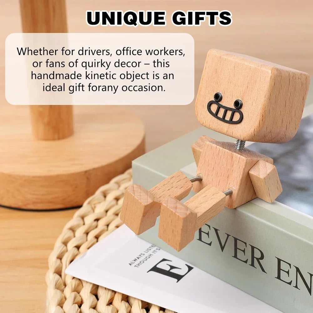Handmade wooden kinetic object figure with magnetic expressions sitting on a green book.