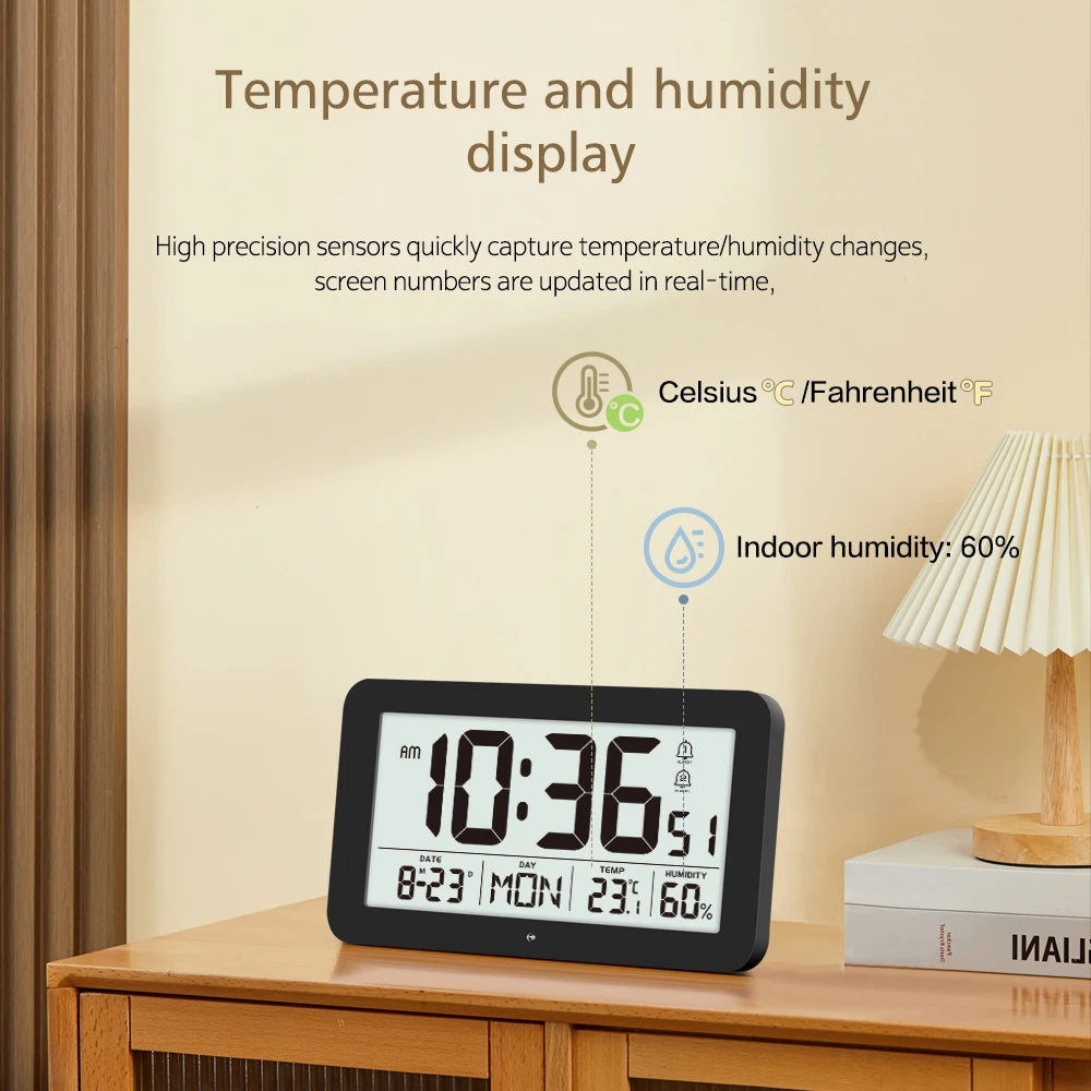 A digital wall clock display showing the time 10:36, temperature, and indoor humidity percentage on a wooden surface.