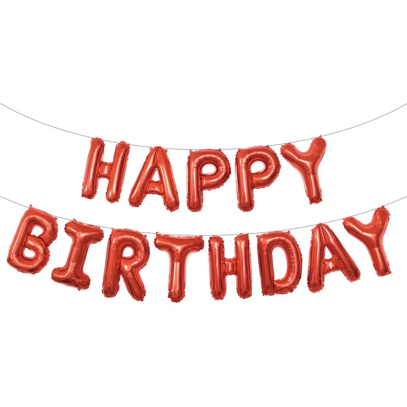 A string of red foil letter balloons spelling out Happy Birthday for party decoration.