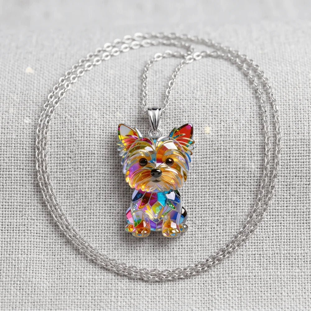 A sparkling acrylic pendant necklace featuring a Yorkshire Terrier charm on a silver chain.