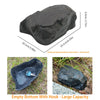 A dark, smooth stone with a hook attached to the bottom, used for hiding keys in the garden.