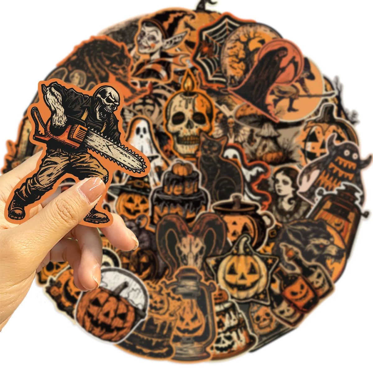 A hand holds an orange sticker featuring a skull and crossbones design on a dark background.
