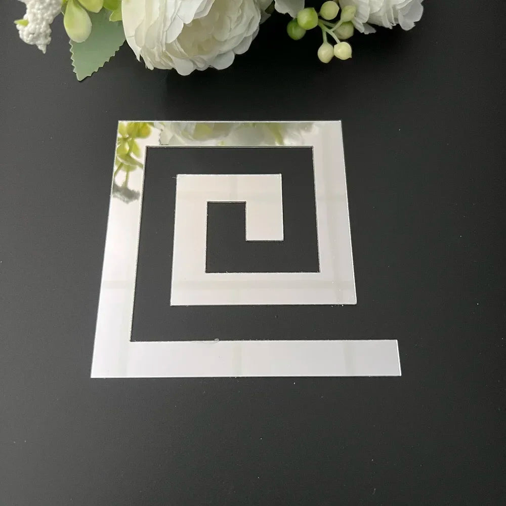 A clear acrylic mirror wall sticker featuring a black swirling maze design on a dark surface.
