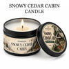 Snowy Cedar Cabin candle in a black tin with a lit wick and decorative label