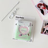 A clear plastic keychain featuring a pink heart design and text, displayed next to a silver chain.