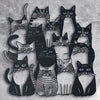 A black silhouette line art of multiple cats arranged in a playful, overlapping pattern.