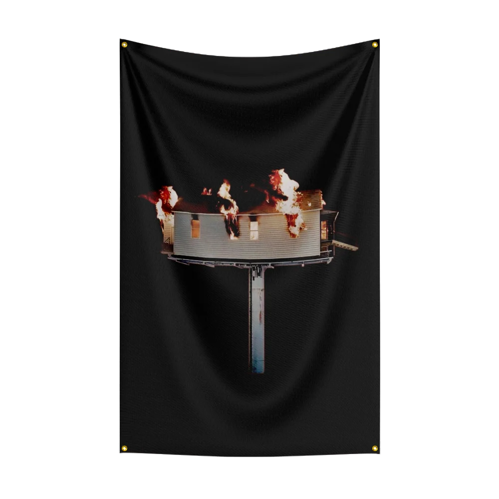 A black fabric tapestry featuring a depiction of a burning flag or banner.