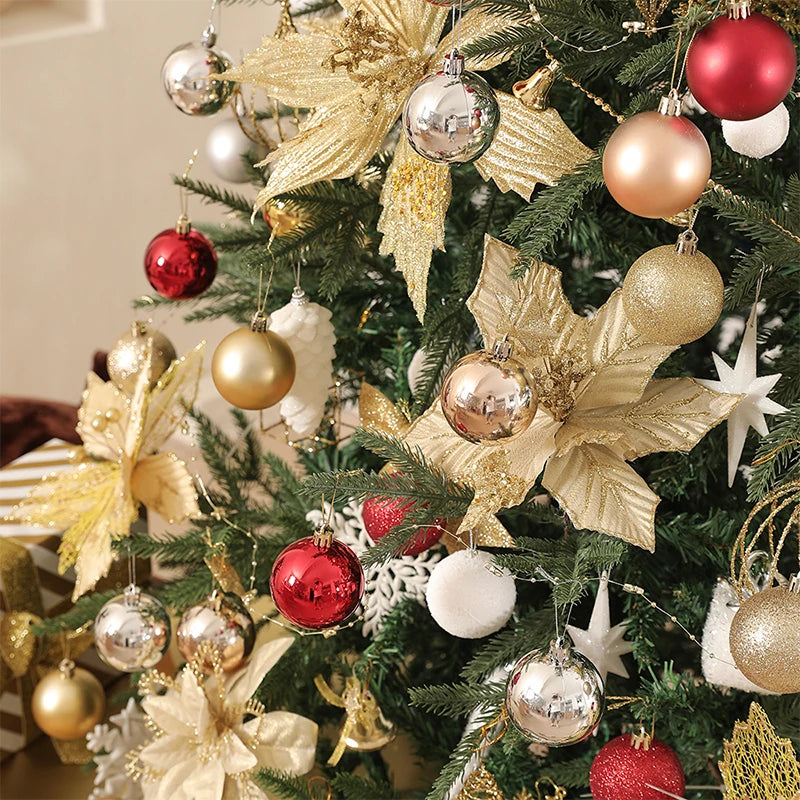 A close-up of a Christmas tree decorated with various gold, silver, and red baubles and star ornaments.