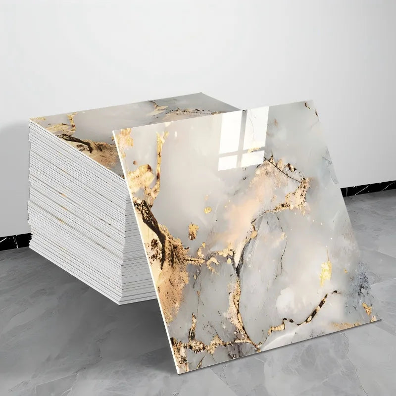 A stack of self-adhesive marble tile stickers featuring gold veining on a white marble background.