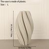 A tall, textured wave vase made of light-colored plastic is shown against a white background.