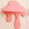 A pink, cherry-shaped wooden wall shelf with a cutout for display, measuring 27cm long and 32cm high.
