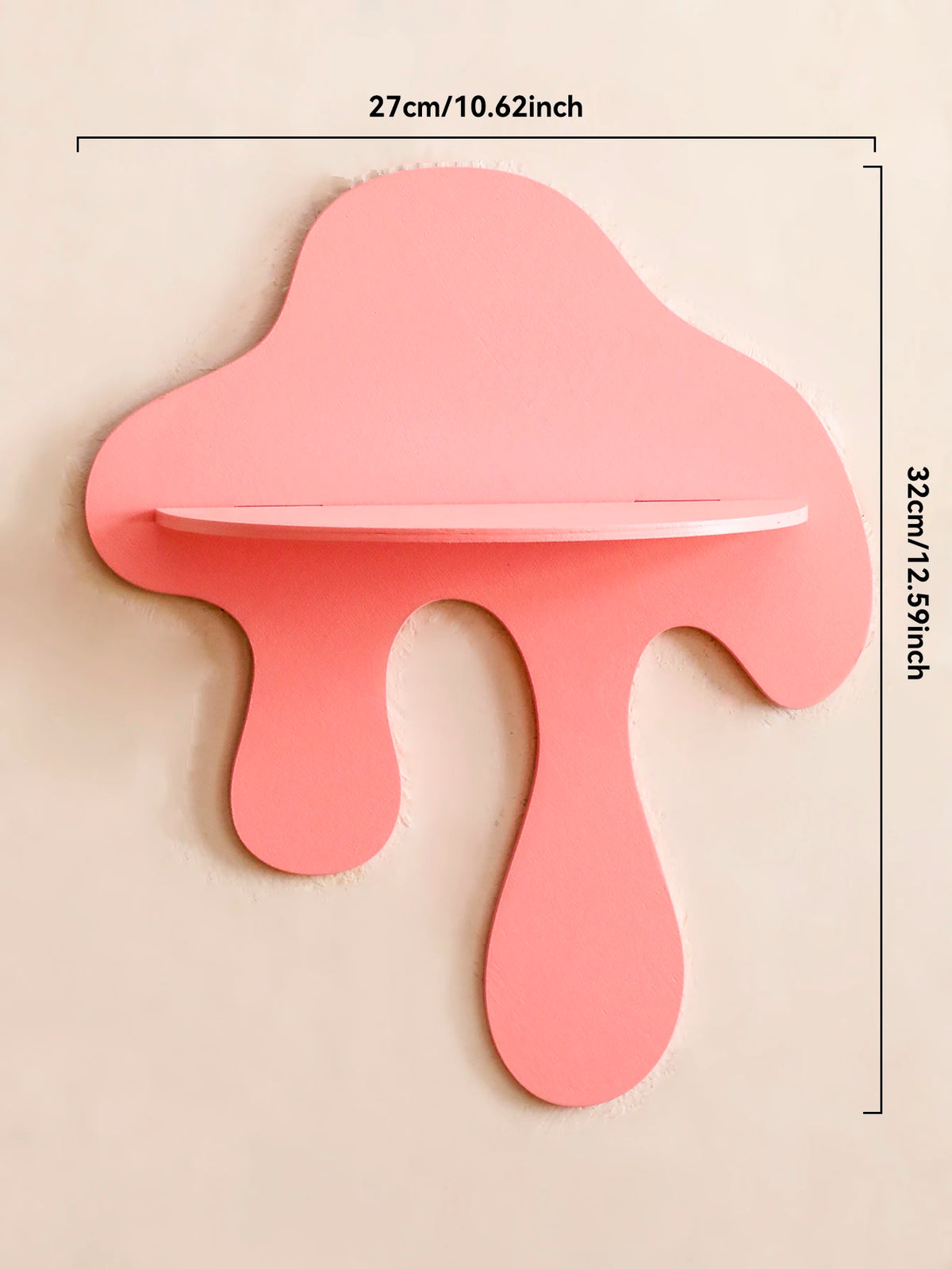A pink, cherry-shaped wooden wall shelf with a cutout for display, measuring 27cm long and 32cm high.