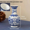 Mini blue and white porcelain vase with a decorative floral pattern shown from the side and top view.