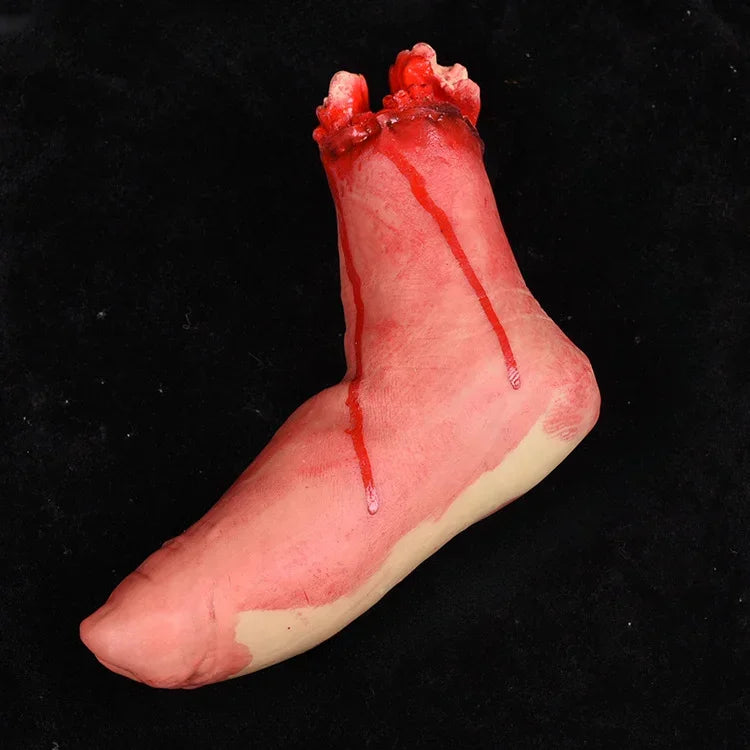 A realistic prop of a severed hand with blood dripping, used for Halloween decor.