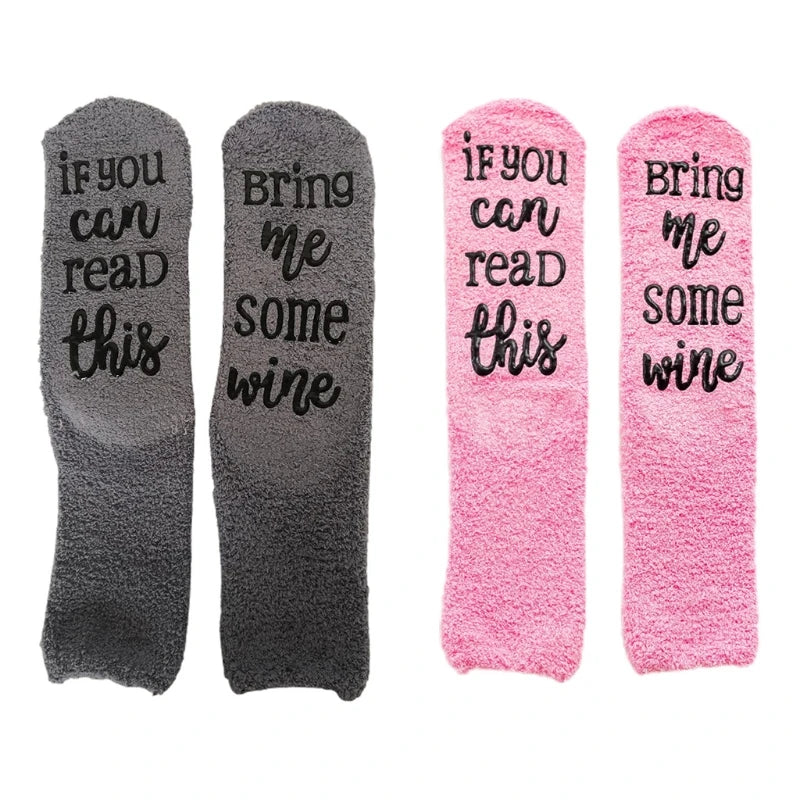 Four fuzzy slippers with funny wine quotes on them in gray and pink colors
