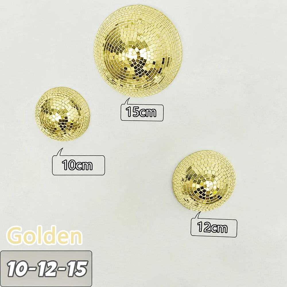 Three gold disco balls of varying sizes are displayed against a white background.