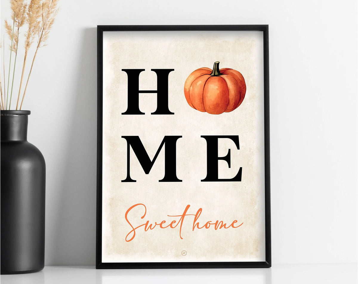 Framed canvas wall art featuring the text HOME and Sweet home with an orange pumpkin illustration on a light background