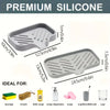 A set of gray silicone kitchen tools including a faucet splash guard, drying mat, sponge, brush, dish soap, and cup/toothbrus