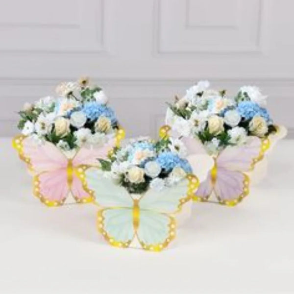 A set of floral butterfly decorations featuring pastel pink and mint green butterflies on a gold background for a garden part