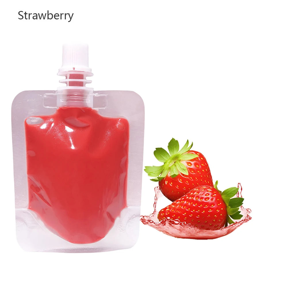 A clear bottle of strawberry lip oil gloss next to fresh strawberries.