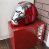 A red and silver Iron Man helmet is displayed on a red box.