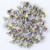 A collection of small, gray and pink silk artificial flower heads used for weddings, crafts, and home decor.