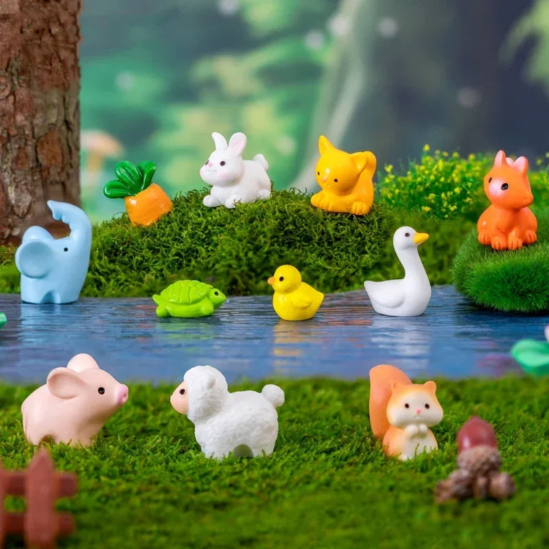 A set of mini animal fairy garden decor featuring rabbits, a pig, a cat, and other small woodland creatures on green moss.